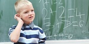 happy young boy at first grade math classes Oral health and school grades