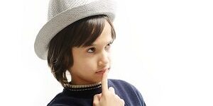 Portrait of happy joyful stylish little boy with hat teeth