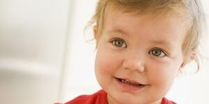 Baby indoors smiling teething