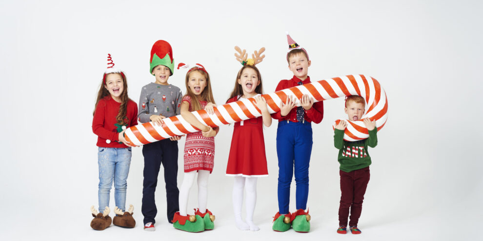 Happy children holding huge candy cane pediatric dentist san diego